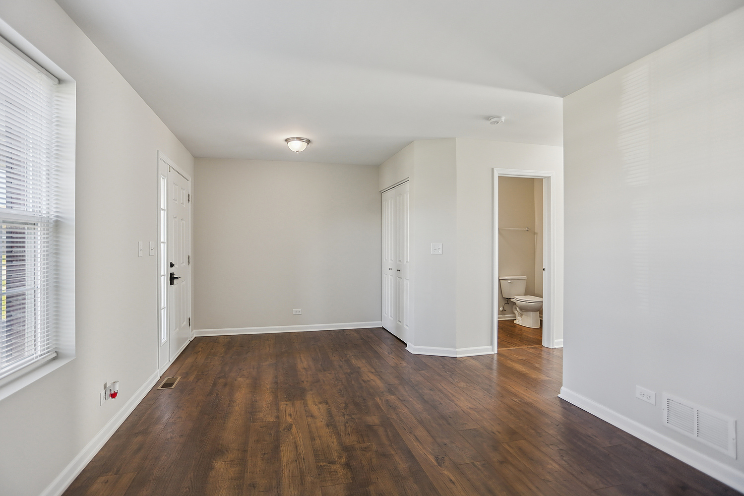 1672 Glenbrooke Lane New Lenox, IL 60451 - Photo 2 of 15 wooden floor in an empty room with a window