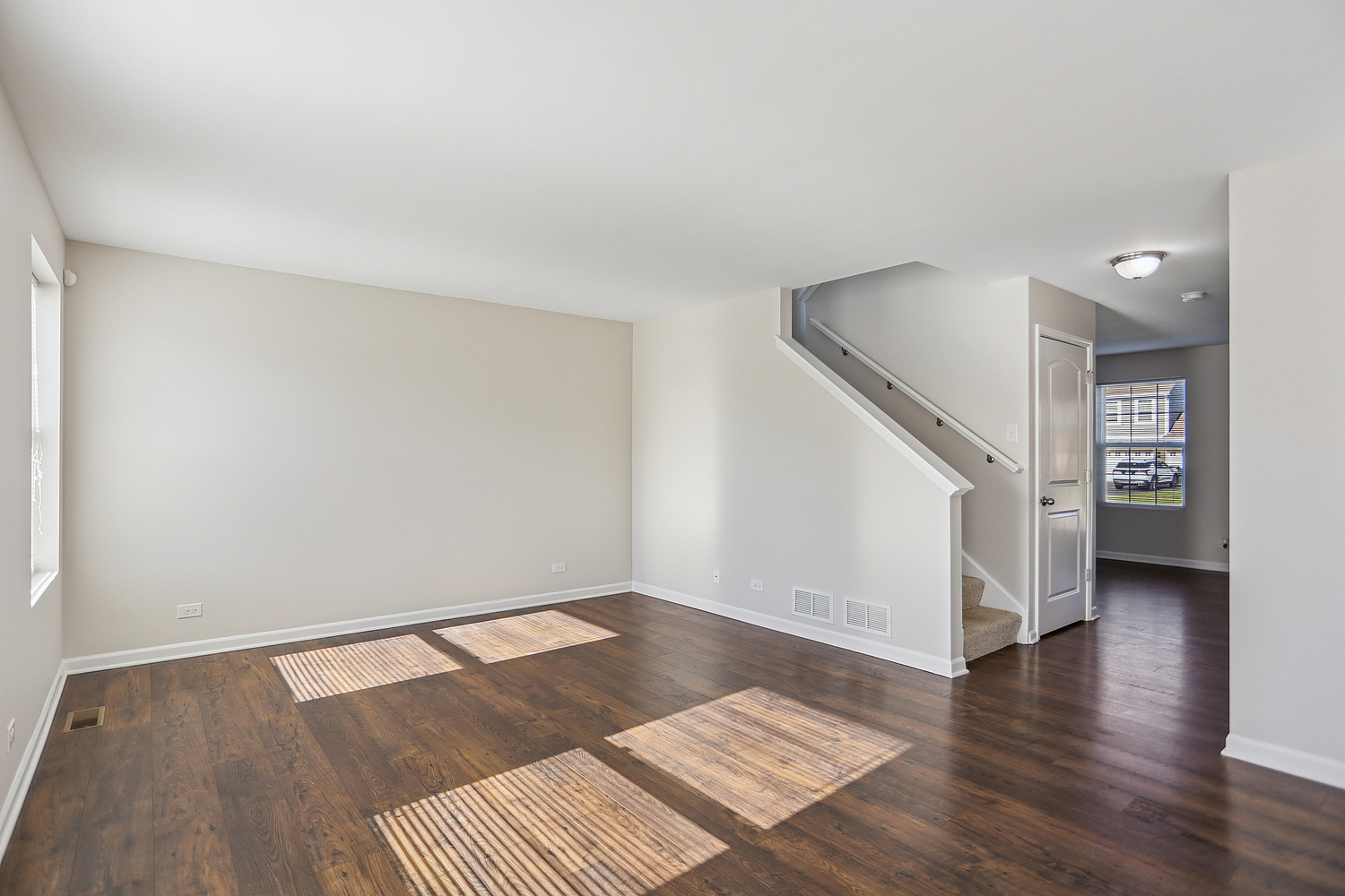 1672 Glenbrooke Lane New Lenox, IL 60451 - Photo 3 of 15 a view of an empty room with wooden floor and a ceiling fan