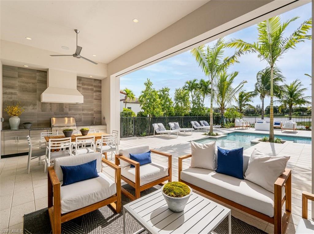 2059 Cambridge Park Drive Naples, FL 34109 - Photo 11 of 15 a living room with patio furniture and a large window
