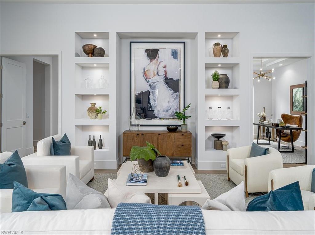 2059 Cambridge Park Drive Naples, FL 34109 - Photo 5 of 15 a living room with furniture a rug and wall painting