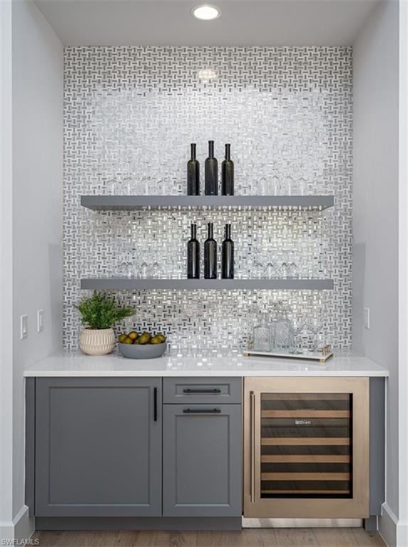 2059 Cambridge Park Drive Naples, FL 34109 - Photo 7 of 15 a kitchen with a sink and cabinets