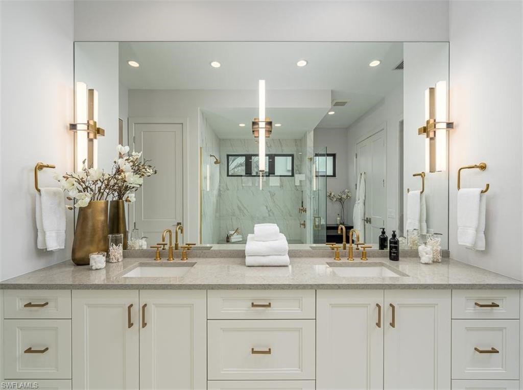 2059 Cambridge Park Drive Naples, FL 34109 - Photo 8 of 15 a bathroom with a sink and a mirror