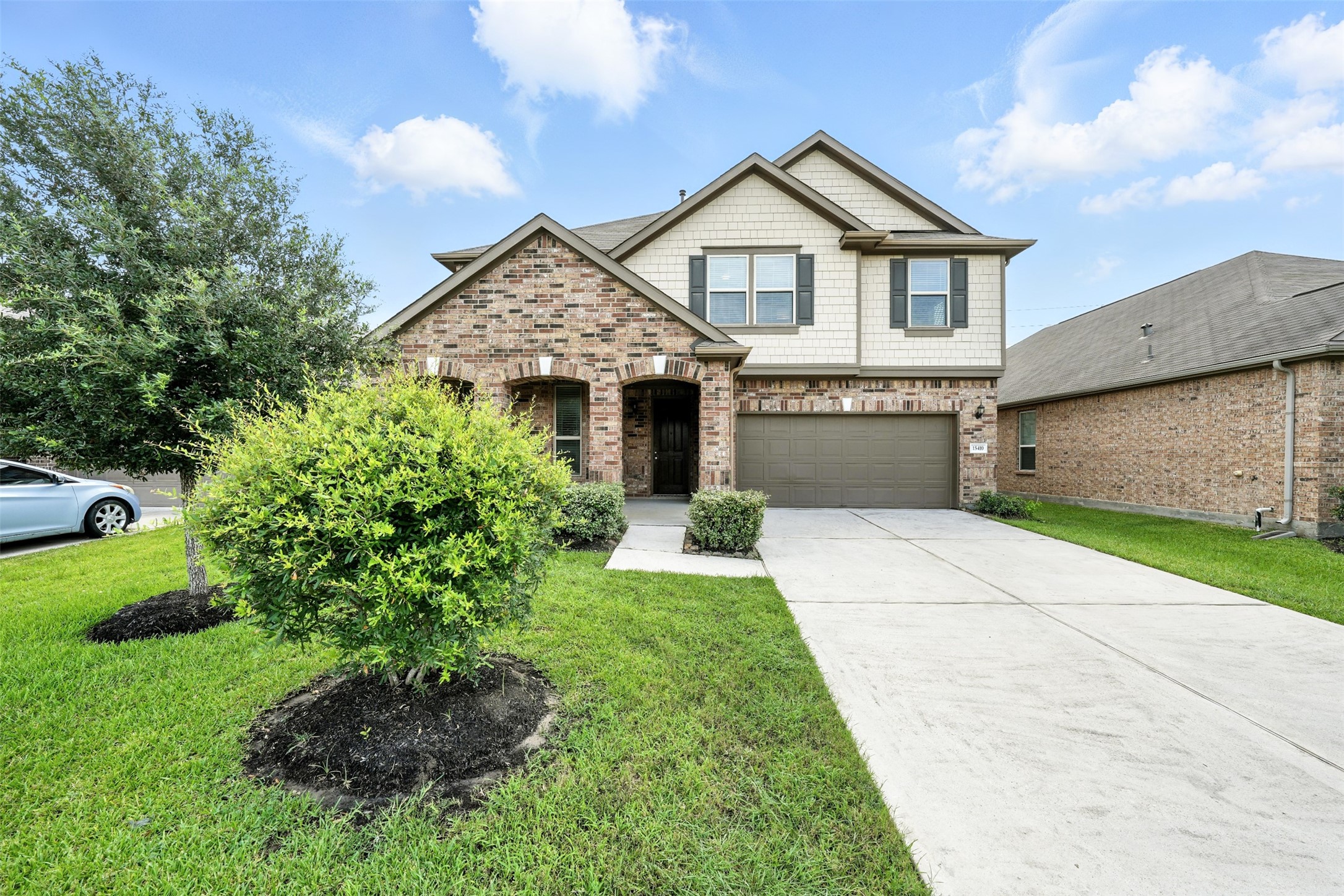 15410 Rosehill Summit Lane Houston, TX 77044 - Photo 1 of 30 a front view of a house with a garden and plants