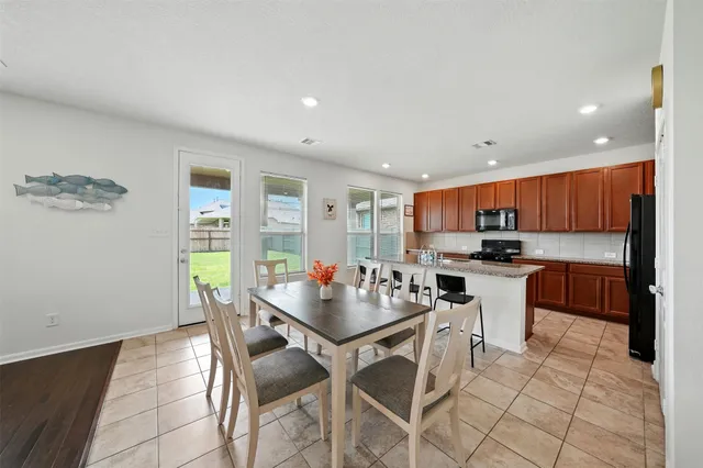 a kitchen with stainless steel appliances kitchen island granite countertop a sink and cabinets