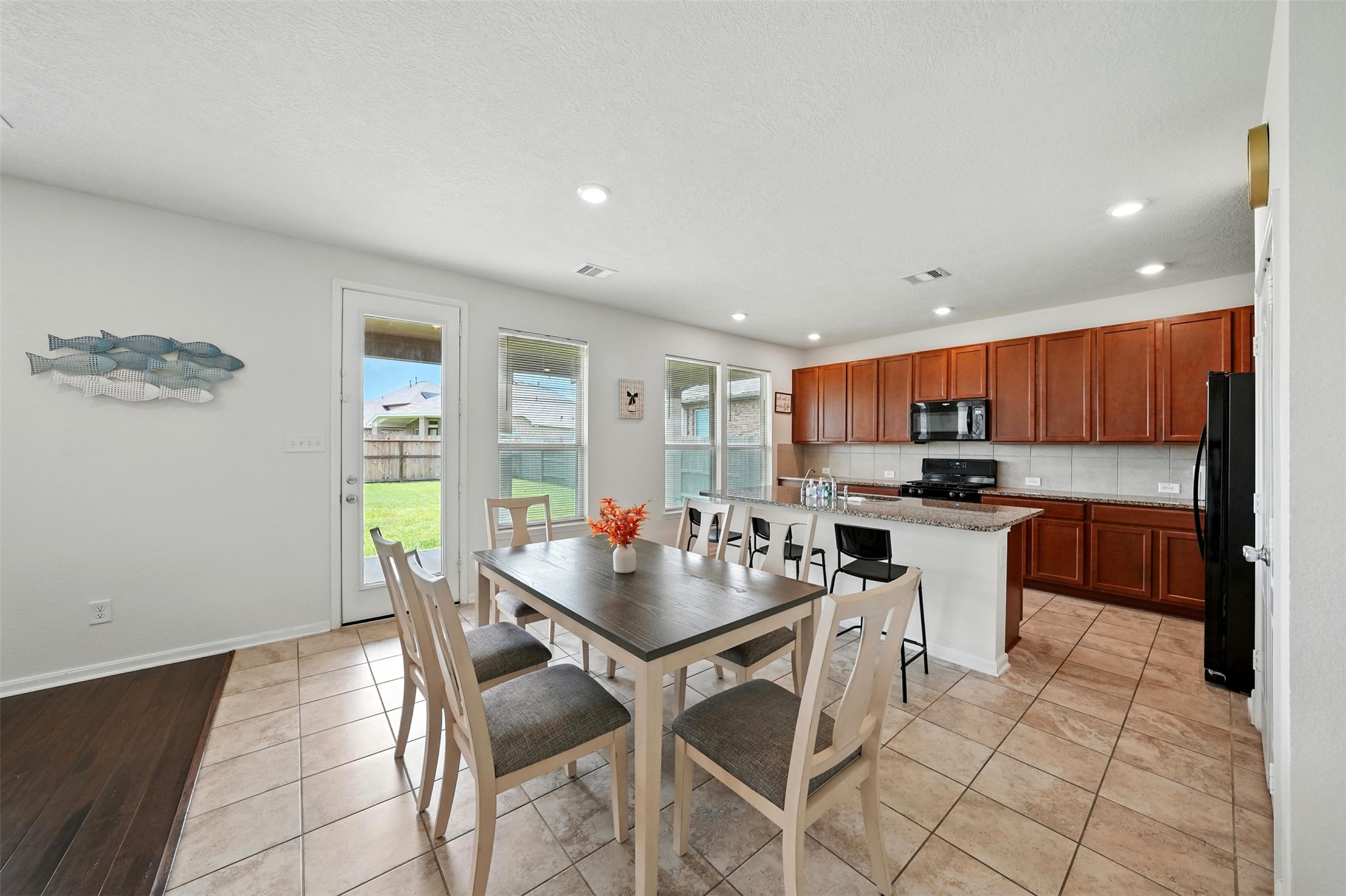 15410 Rosehill Summit Lane Houston, TX 77044 - Photo 11 of 30 a kitchen with stainless steel appliances kitchen island granite countertop a sink and cabinets