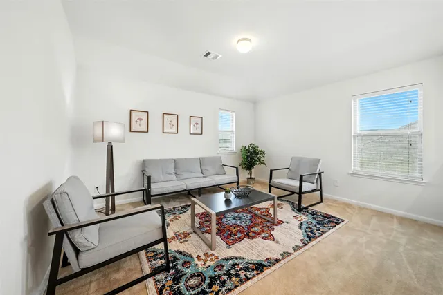 a living room with furniture and a window