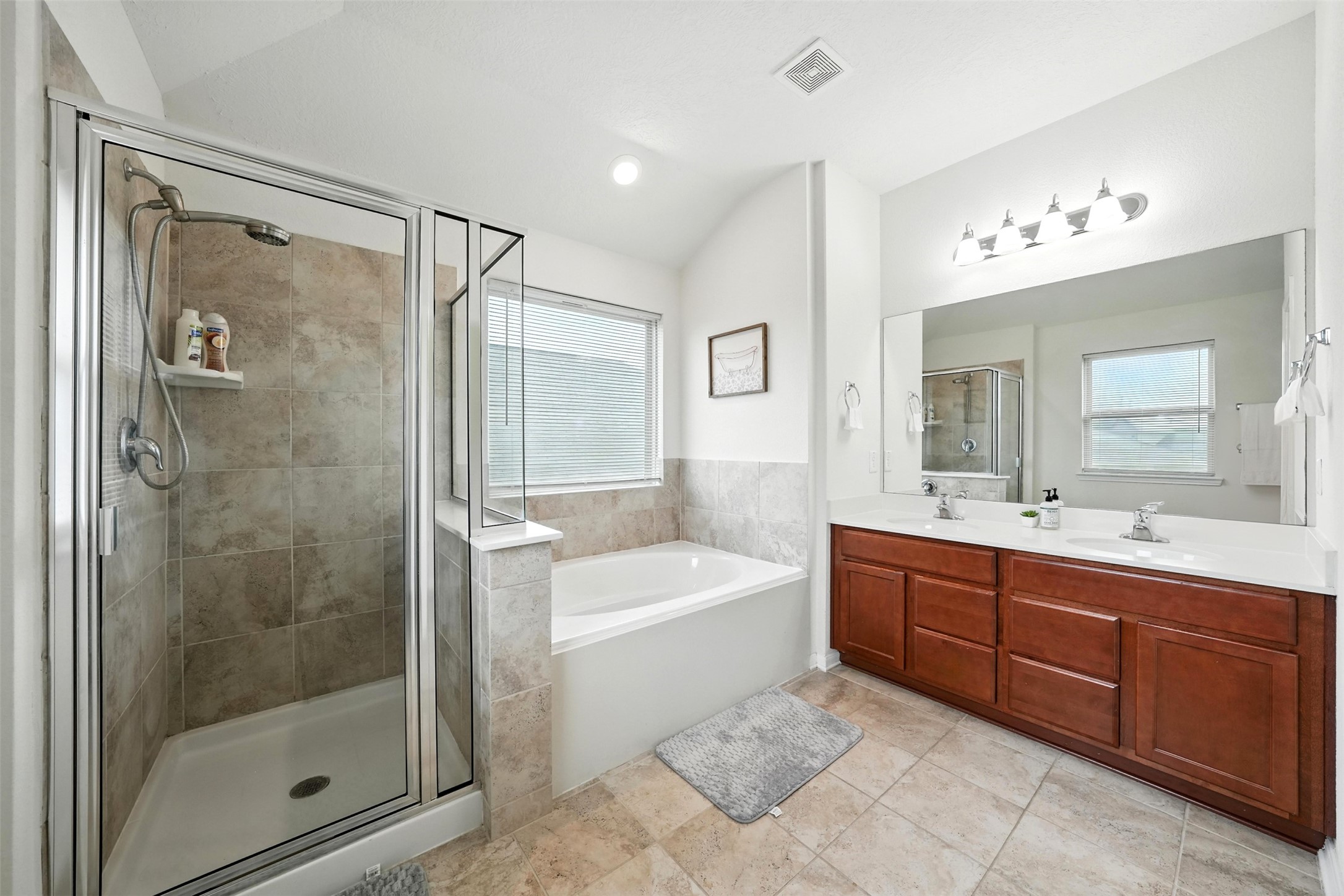 15410 Rosehill Summit Lane Houston, TX 77044 - Photo 18 of 30 a bathroom with a tub sink shower and mirror