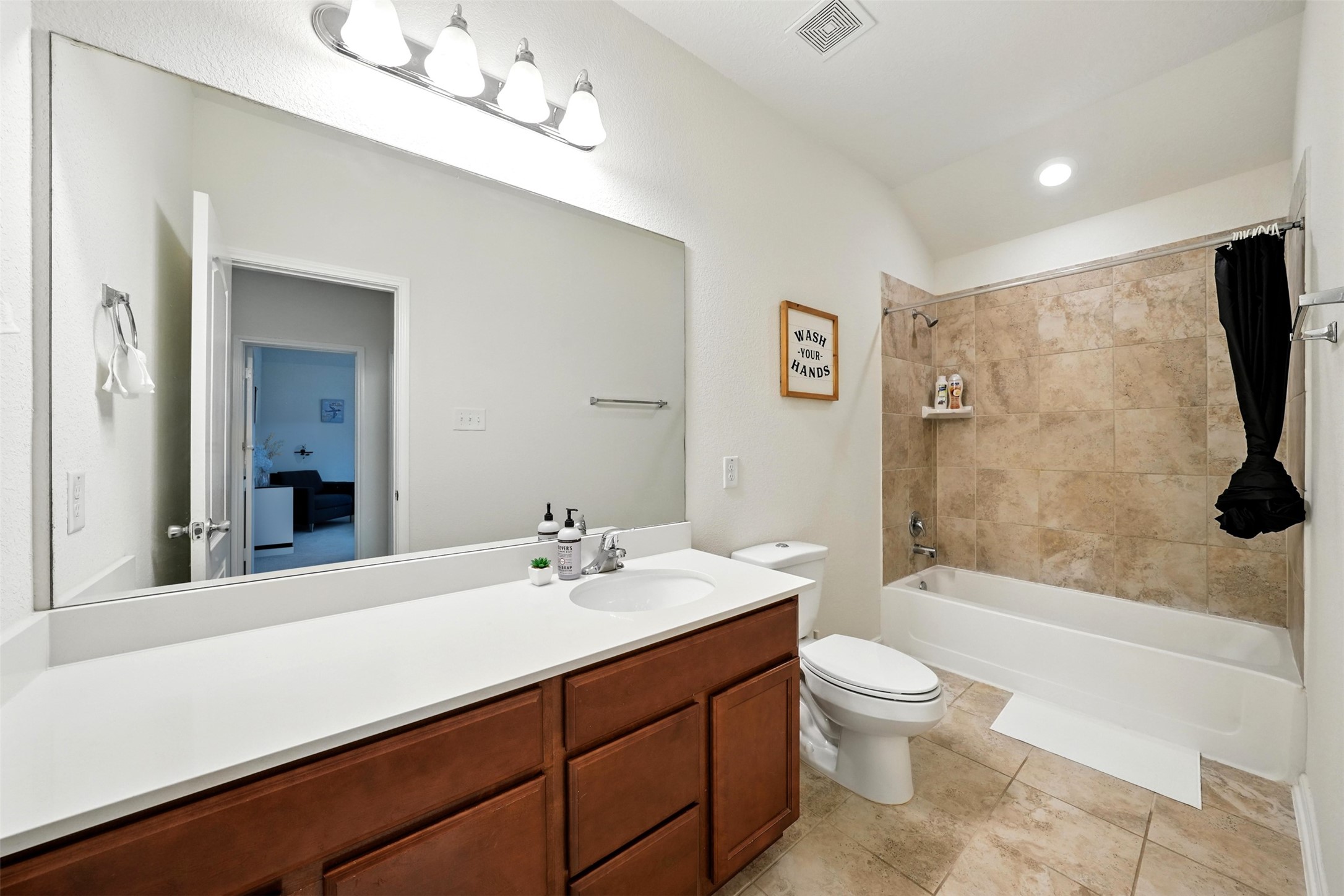 15410 Rosehill Summit Lane Houston, TX 77044 - Photo 20 of 30 a bathroom with a sink a toilet a mirror and shower