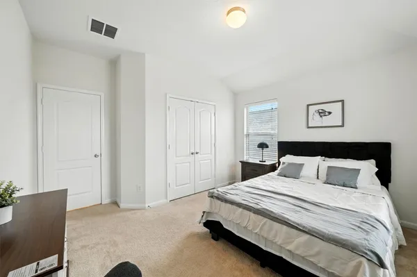 a bedroom with a bed and a couch