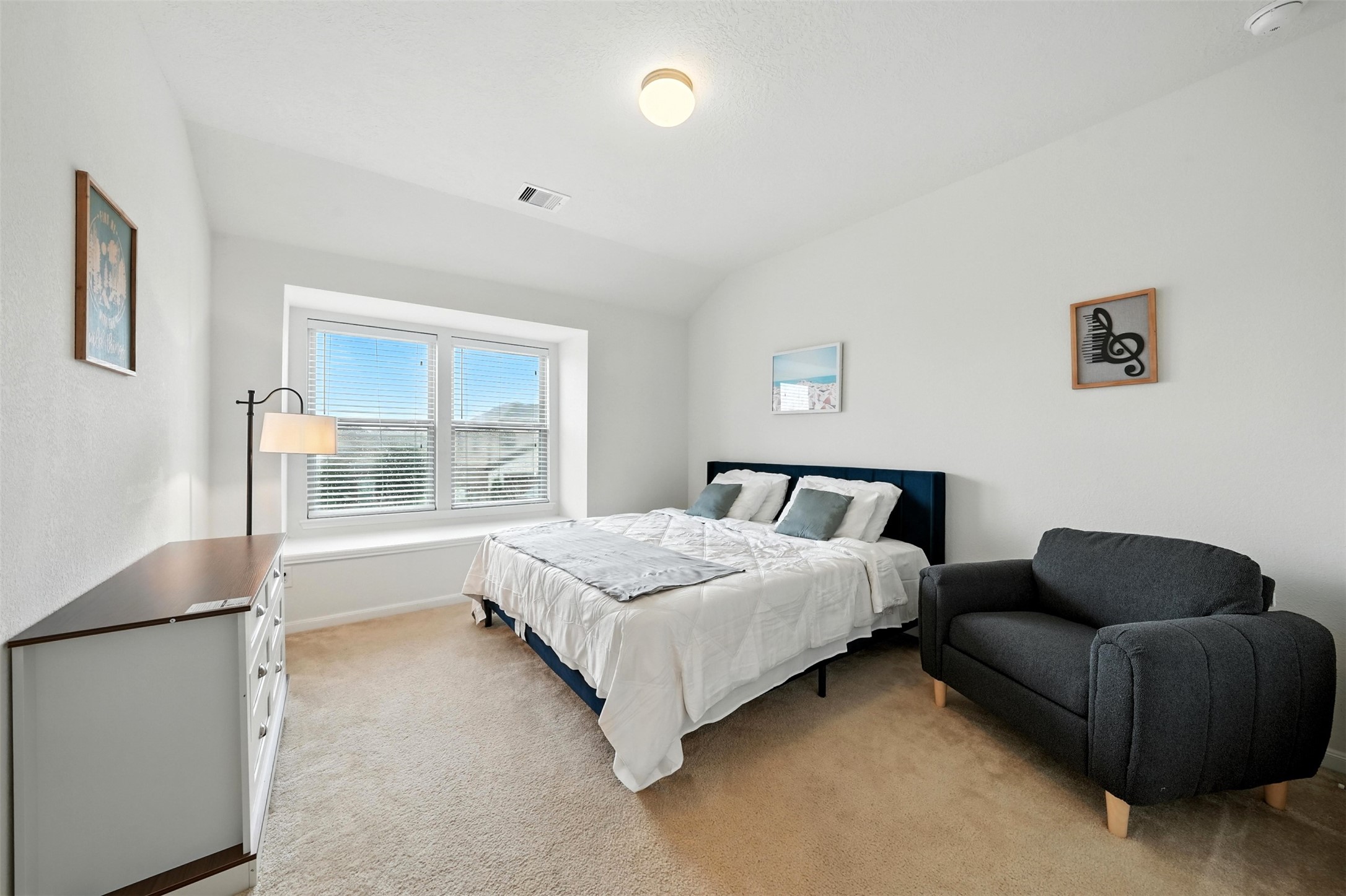 15410 Rosehill Summit Lane Houston, TX 77044 - Photo 25 of 30 a spacious bedroom with a bed and a couch
