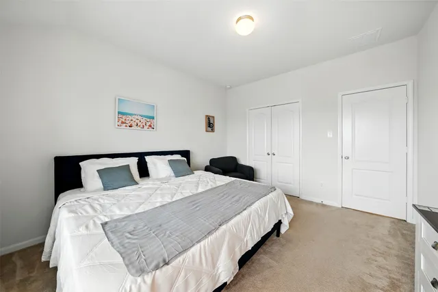 a bed room with a bed and a painting