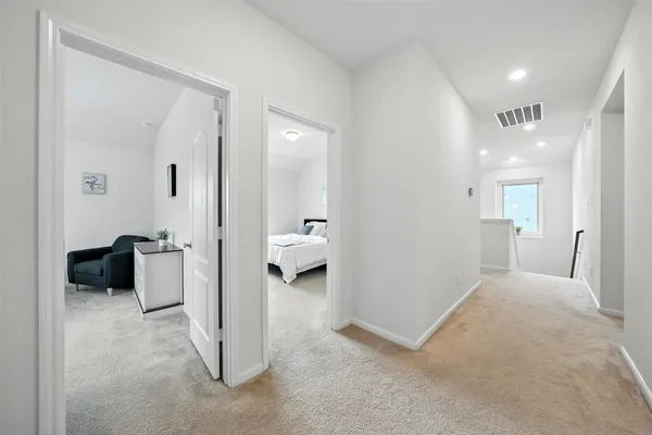 a view of a livingroom with a couch and a large mirror