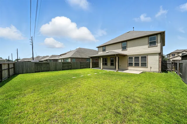 a view of a house with a backyard
