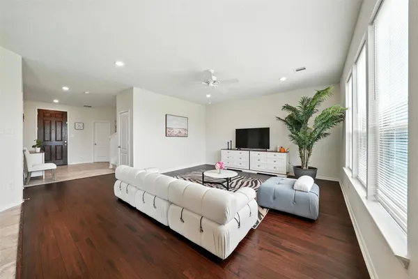 a spacious bedroom with a bed and a large window
