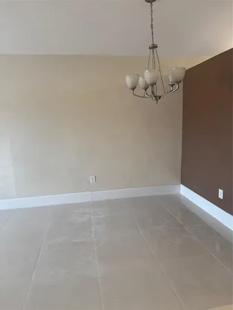a view of a room with an empty space and a ceiling fan