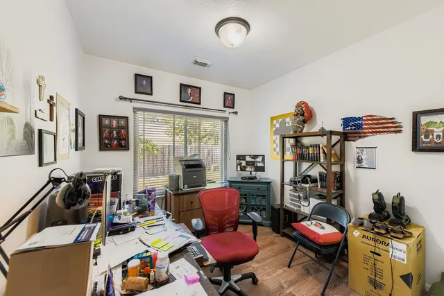 a living room with furniture a flat screen tv and a window