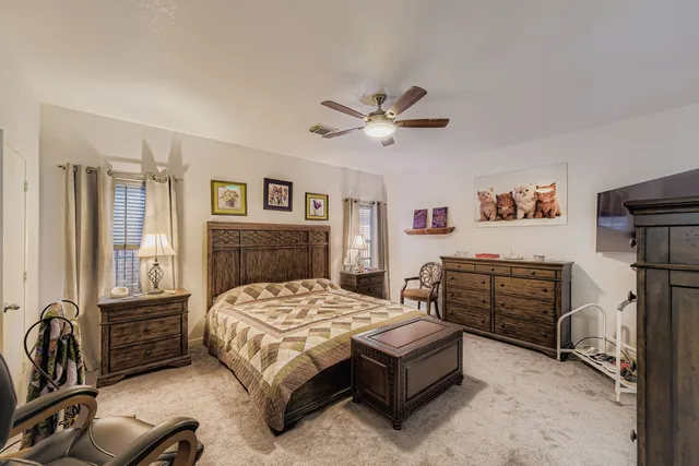 a bedroom with a bed dresser and a window