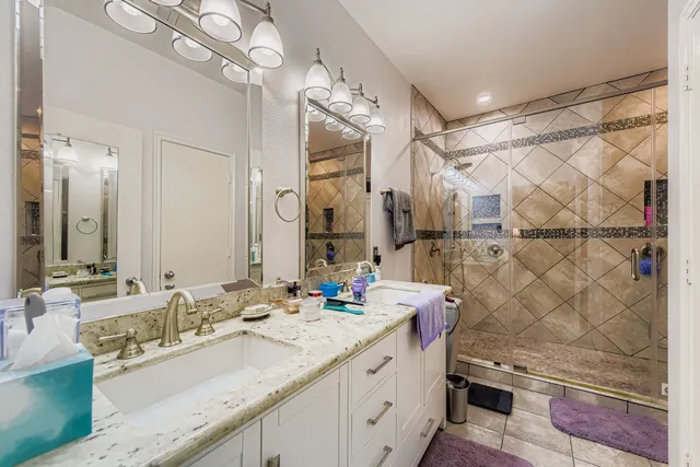 a bathroom with a sink vanity granite and a mirror