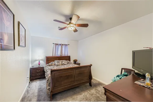 a bedroom with a bed and a desk