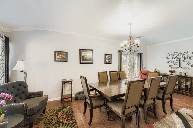 a view of a dining room with furniture and chandelier