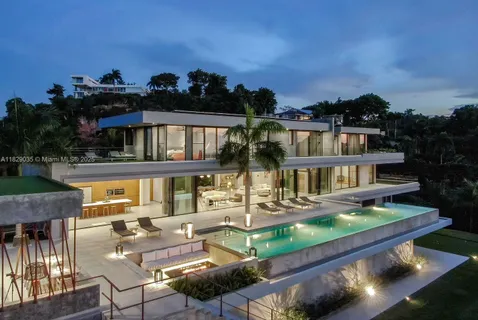 an aerial view of a house with balcony swimming pool and furniture