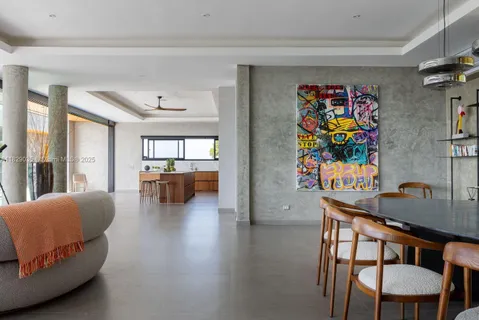 a living room with furniture and painting on the wall