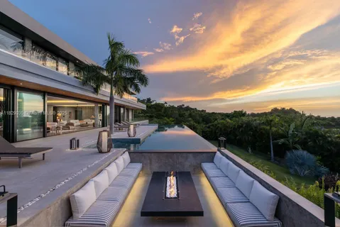 a view of a house with a swimming pool and a yard