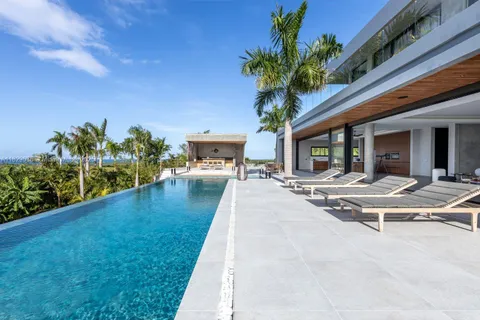 a view of a house with swimming pool and sitting area