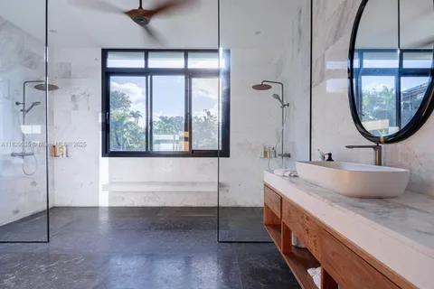 a bathroom with a double vanity sink a mirror and a bathtub