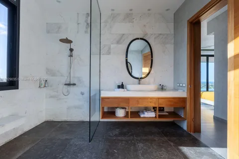 a view of bathroom with shower and mirror