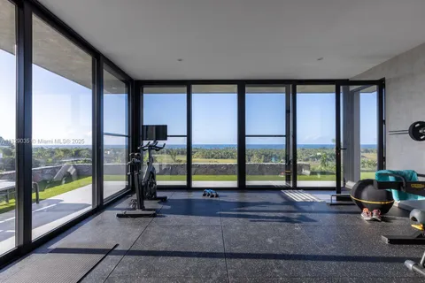 a living room with hardwood floor and large windows