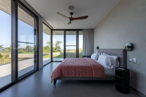 a bedroom with a bed and a large window