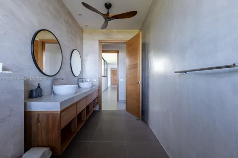 a bathroom with a granite countertop sink a mirror and a shower