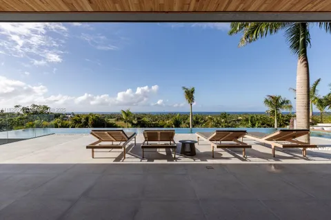 a view of swimming pool with lounge chairs