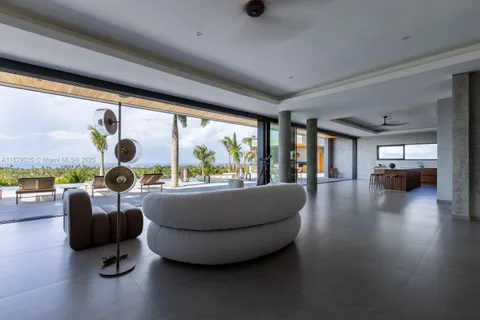 a living room with furniture and a floor to ceiling window