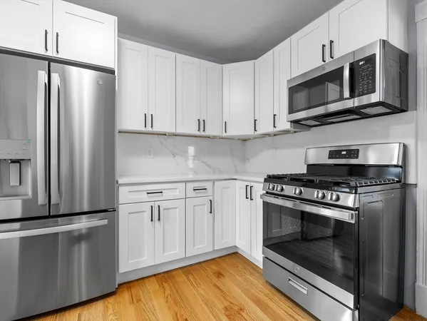 a kitchen with stainless steel appliances a stove a microwave and a refrigerator