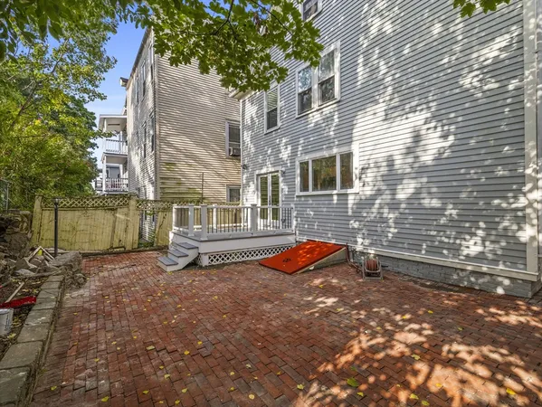 a view of a house with backyard and sitting area