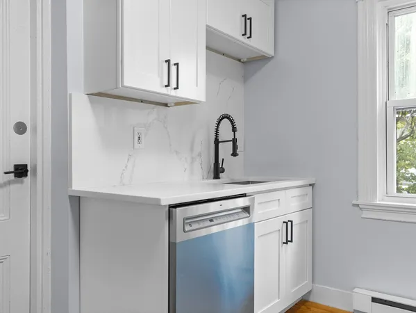 a kitchen with stainless steel appliances a sink and cabinets