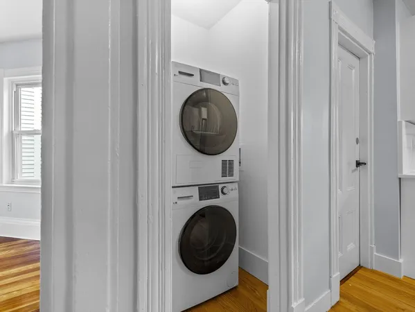 a view of a bedroom with washer and dryer