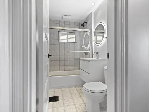 a bathroom with a toilet a sink and a shower