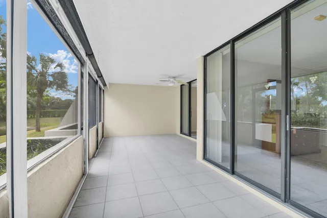 a view of a hallway with a glass door and a glass door