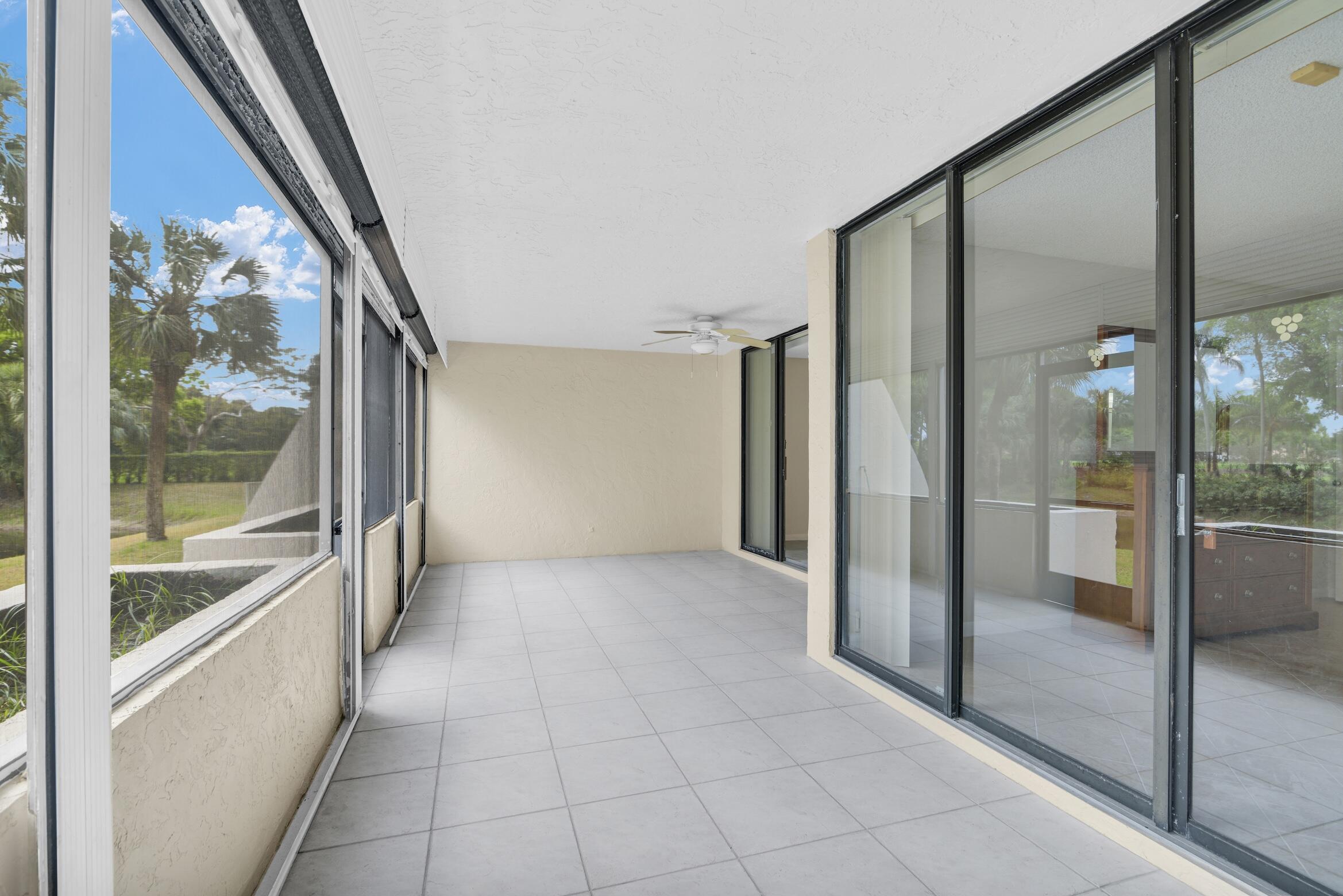 6620 Boca De Mar Drive, Unit 105 Boca Raton, FL 33433 - Photo 20 of 32 a view of a hallway with a glass door and a glass door