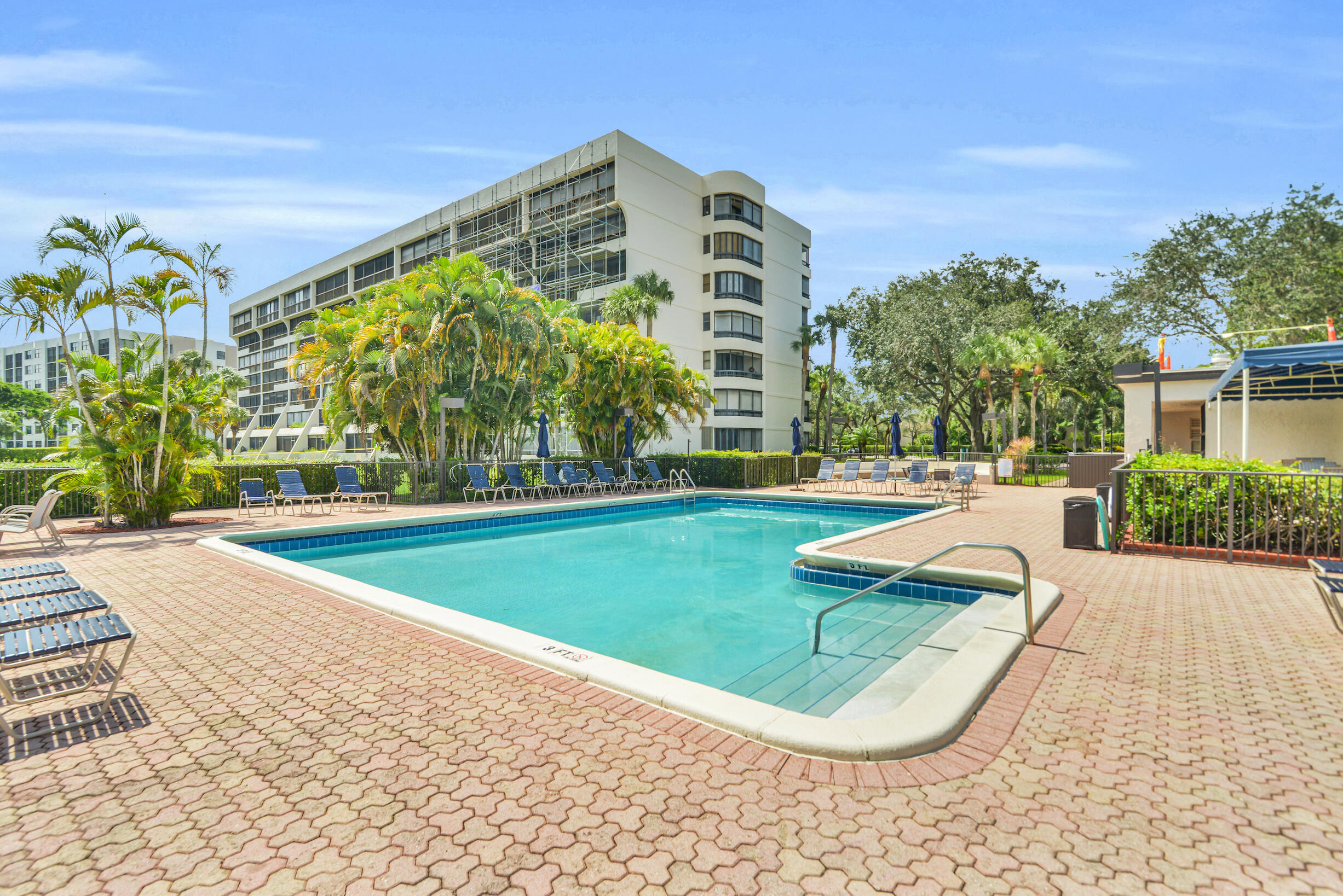 6620 Boca De Mar Drive, Unit 105 Boca Raton, FL 33433 - Photo 25 of 32 a view of a swimming pool with a building in the background