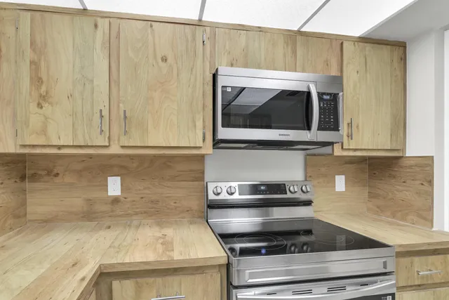 a kitchen with a stove and a microwave