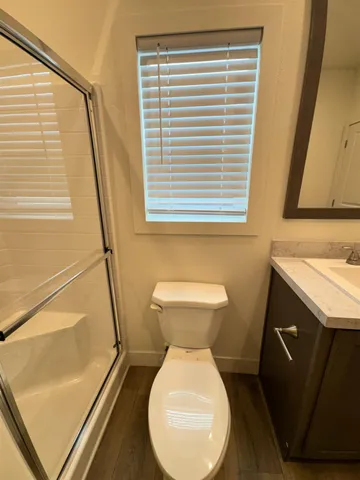 a bathroom with a toilet sink and a mirror