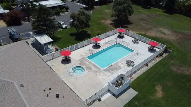 an aerial view of a house swimming pool and outdoor space