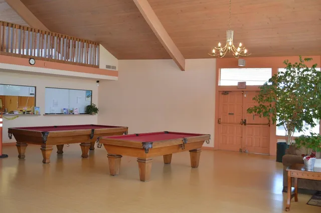 a dining room with furniture and chandelier