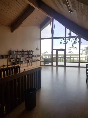 a view of a room with lots of wooden floor and windows