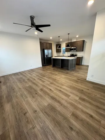 a view of kitchen with stainless steel appliances refrigerator stove microwave and cabinets