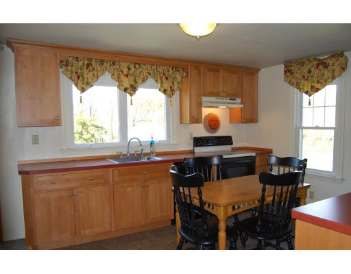 170 Westboro Road Upton, MA 01568 - Photo 8 of 15 a living room with a table chairs and a refrigerator